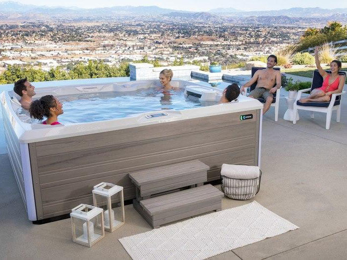 A group of friends using a Hot Spring Limelight® Prism® on a summer day