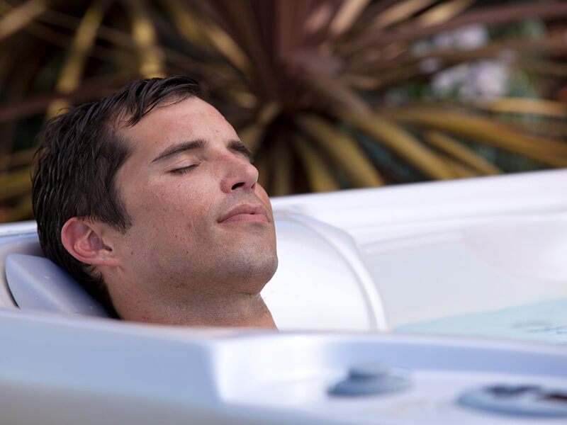 A couple enjoying a relaxing soak in a Hot Spring Hot Spot 2014 Tempo hot tub with Pearl Espresso finish.