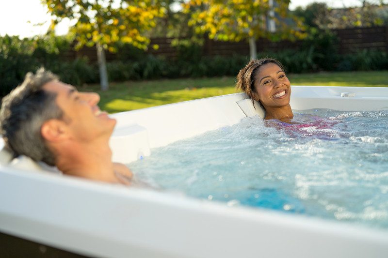 A couple enjoys the relaxing benefits of hot tub use.